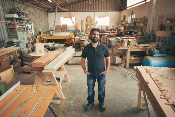 istock Proud owner of a carpentry workshop smiling at the camera 2182261690