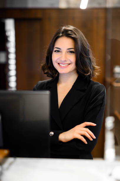 istock Young receptionist smiling at the camera in a hotel 2182261749