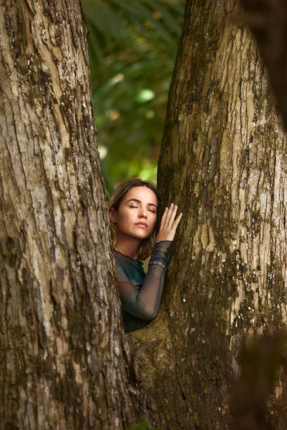 istock Serene woman between trees in nature. 2182264394