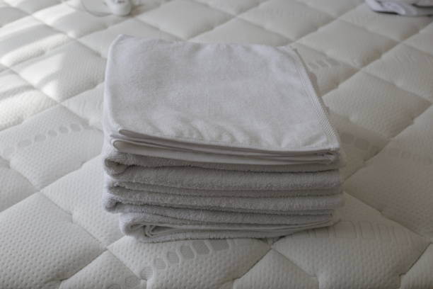 istock Stack of white towels in bed room 2182265585