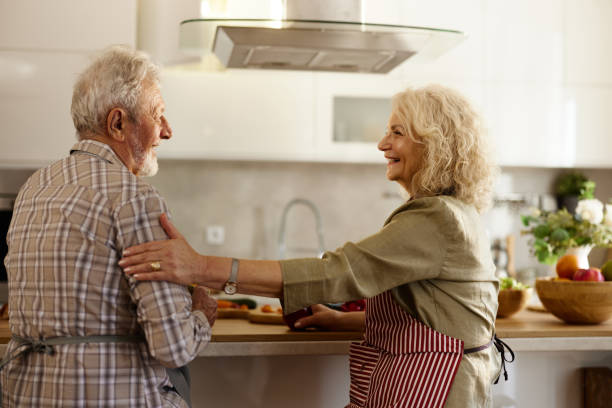 istock Happy mature couple enjoying in conversation at the kitchen. 2182267552