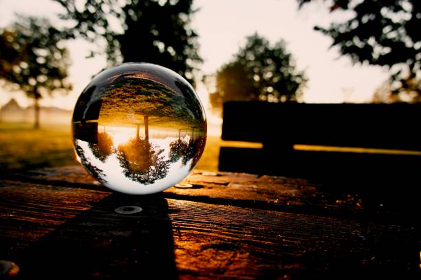 istock Crystal ball on wooden table in park during sunrise 2182268295