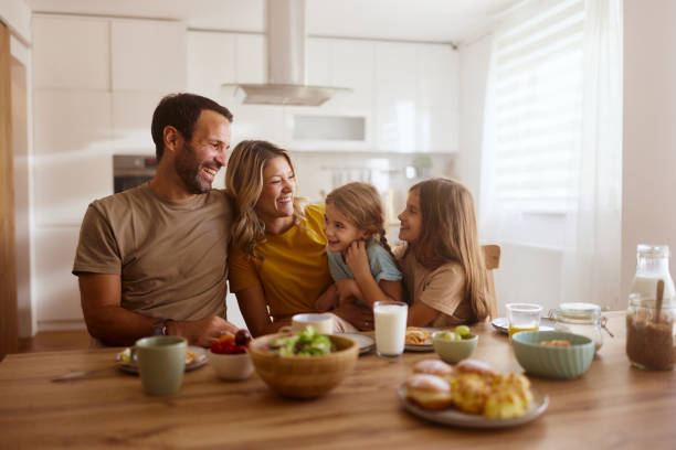 istock Happy family talking while having breakfast in dining room. 2182268363