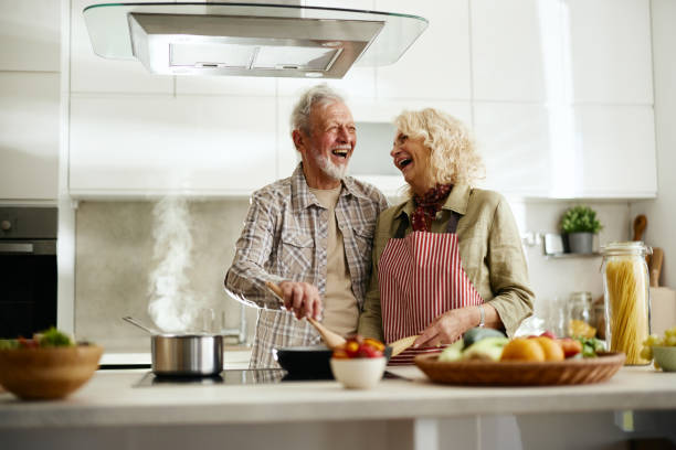 istock Cheerful senior couple having fun while cooking in the kitchen. 2182269307