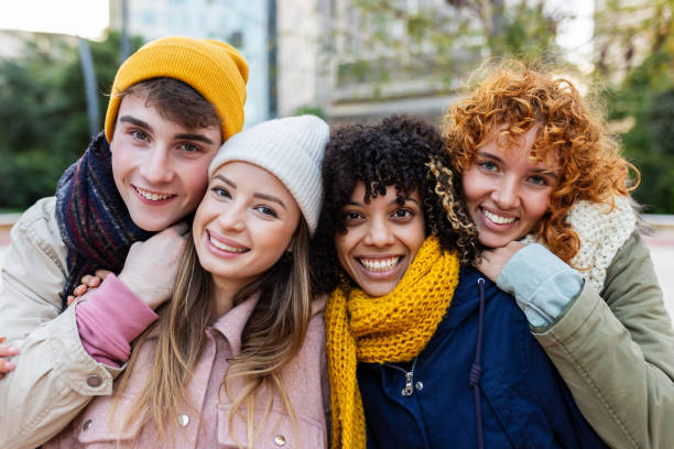istock Young group of diverse people smiling at camera standing outdoors in winter 2182279528