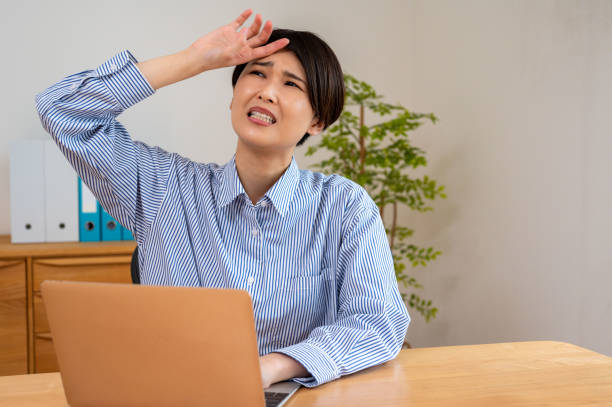istock A woman who is in poor health working on a computer 2182287337