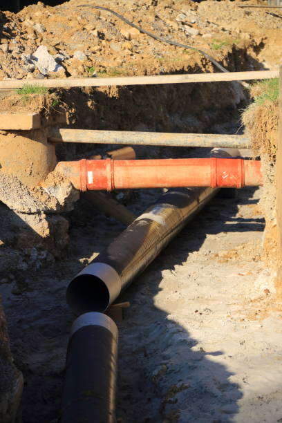 istock Cables and pipes are laid in a construction pit 2182288040