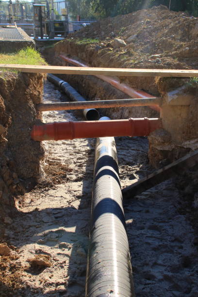istock Cables and pipes are laid in a construction pit 2182288049