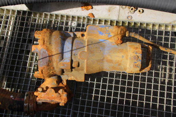 istock Old pump with muddy casing lies on a grid 2182288328