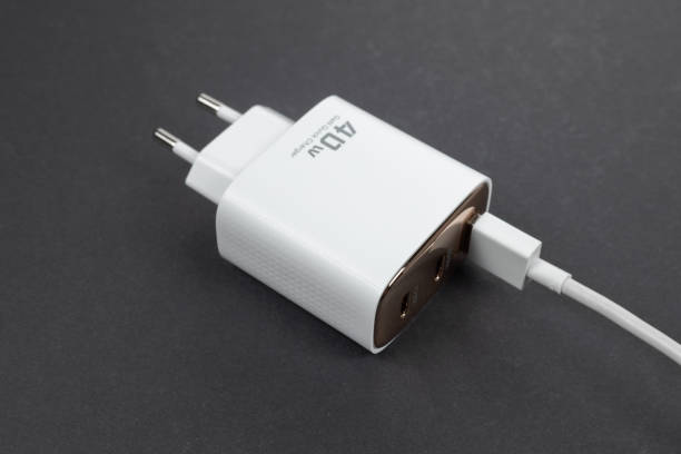 istock White phone AC charger and USB cable on dark background 2182290575