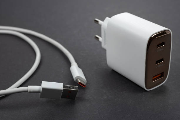 istock White smartphone charger and USB cable on dark background 2182290594