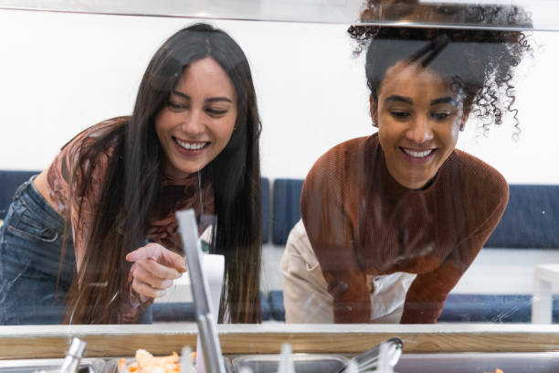istock Multiethnic women choosing food in restaurant 2182294870