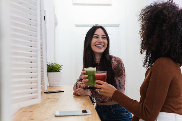 istock Cheerful diverse women drinking smoothie in bar 2182295251