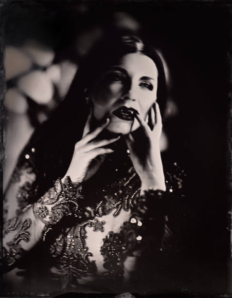 istock Female vampire stands in front of gothic window (4 of 4). Atmospheric lighting,  19th century process called wetplate collodion 2182297039