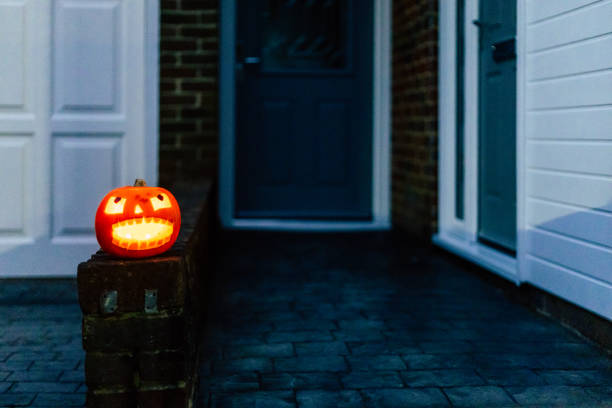 istock Illuminated Jack O' Lantern outside residential house on Halloween 2182298083
