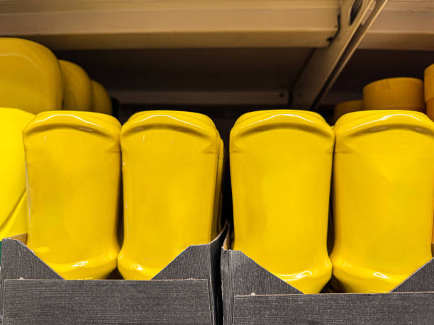 istock Bright Yellow Mustard Bottles on Shelf 2182304060