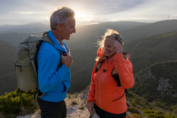 istock Mature couple hike along sunny mountain ridge 2182305562