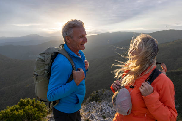 istock Mature couple hike along sunny mountain ridge 2182305627