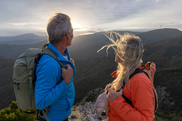 istock Mature couple hike along sunny mountain ridge 2182305648