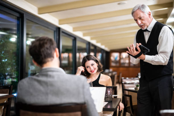 istock Senior waiter taking order with digital tablet in elegant restaurant 2182306479