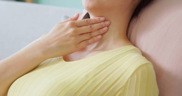 istock asian woman has sore throat 2182308945