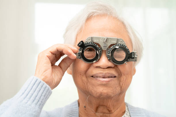 istock Asian senior woman wearing ophthalmic vision eye test and using optical trial frame. 2182313353