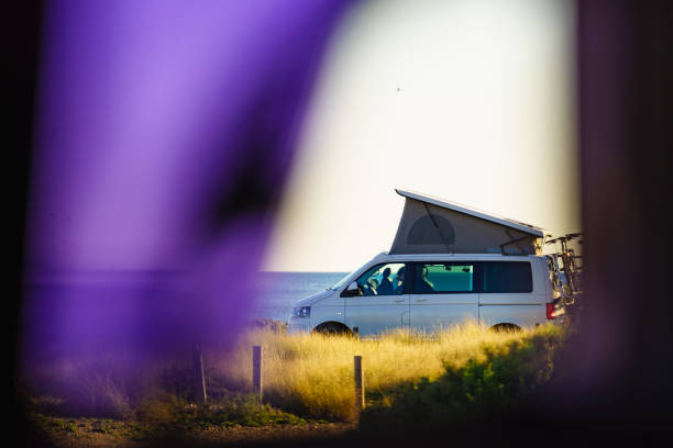 istock Camper van with roof top tent camp on beach 2182313440