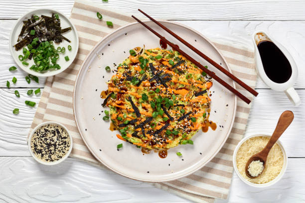 Japanese pancake with cabbage on a plate, top view