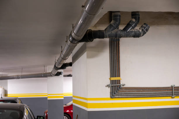 istock Underground Parking Garage With Visible Industrial Pipes 2182316845