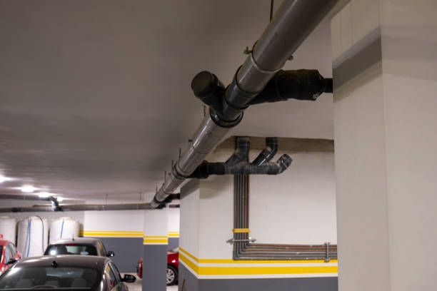 istock Underground Parking Garage With Visible Industrial Pipes 2182316855