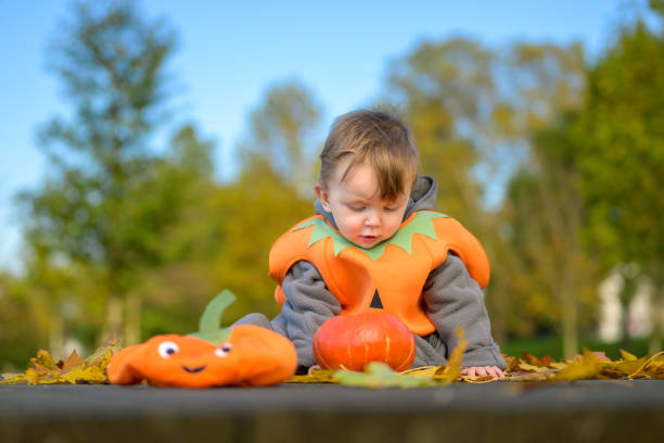 istock Thoughtful Toddler in Pumpkin Costume 2182317550