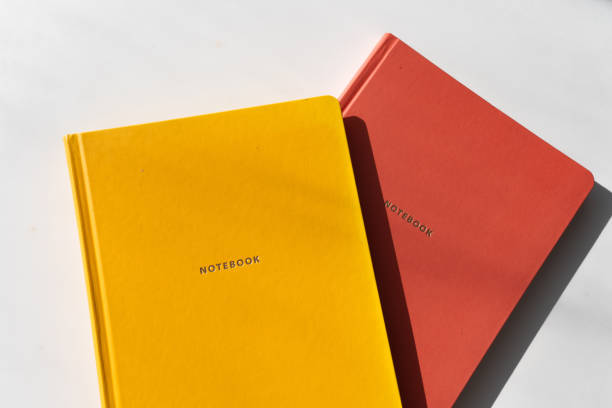 istock Yellow and Red Notebooks on White Background with Minimalist Aesthetic for Office and Study Themes 2182319447