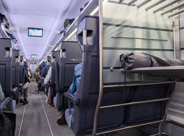 istock High speed train interior with passengers. A suitcase is on the metalic baggage zone . Travel concept, ICE, GermanyGermany 2182320128