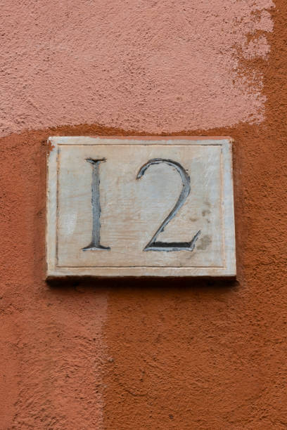 istock Carved number twelve door number on plaster wall background 2182321035