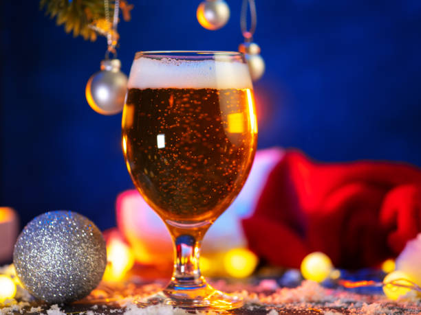 istock Light Beer glass on a Christmas decorated blue background 2182321634