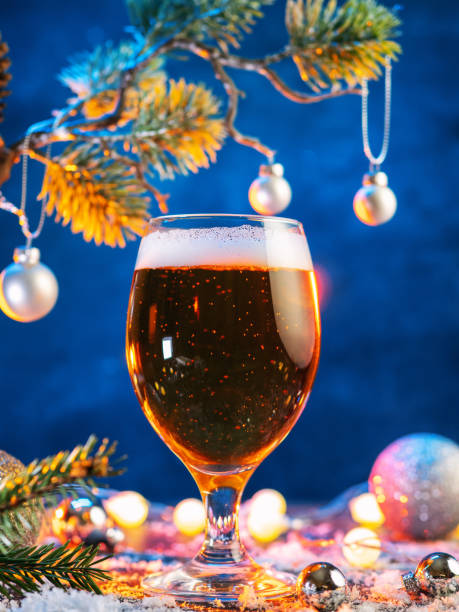 istock Light Beer glass on a Christmas decorated blue background 2182321645