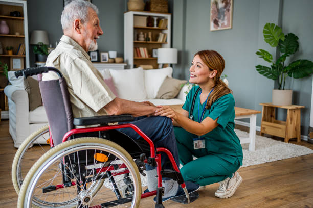istock Senior man with disability talking with female home nurse 2182321952