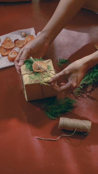 istock Hand tying a ribbon of twine on a gift box 2182323065