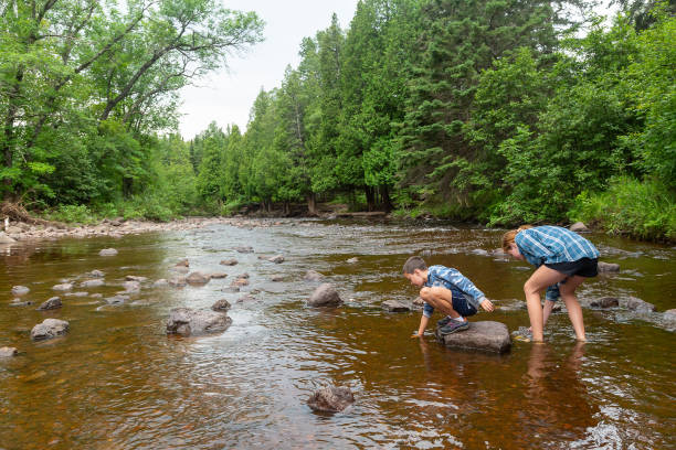 istock Girl & Boy in Gooseberry River 2182323139