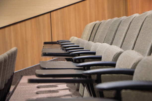 The neatly arranged blue chairs in the meeting room