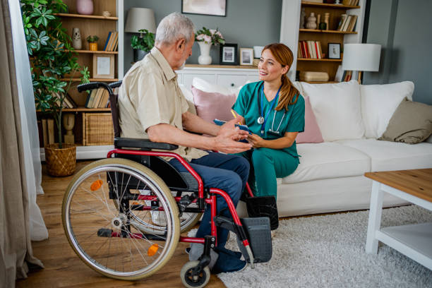 istock Home nurse visiting disabled senior male patient at home 2182323621