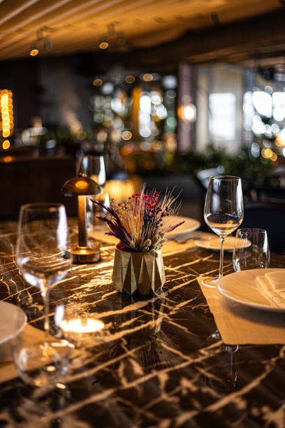 istock Elegant restaurant interior with decorative centerpiece on a polished marble table, warm lighting, and luxurious ambiance in Istanbul, Turkey 2182329058