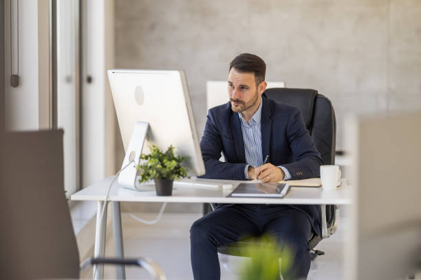 istock Focused Business Professional Working At Modern Office Desk 2182329322