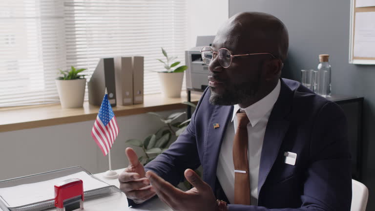 Black Consular Officer Explaining Reasons for Rejecting US Visa Applications