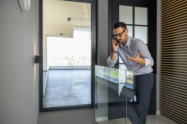 istock Business Professional Speaking on Smartphone in Modern Office 2182331262