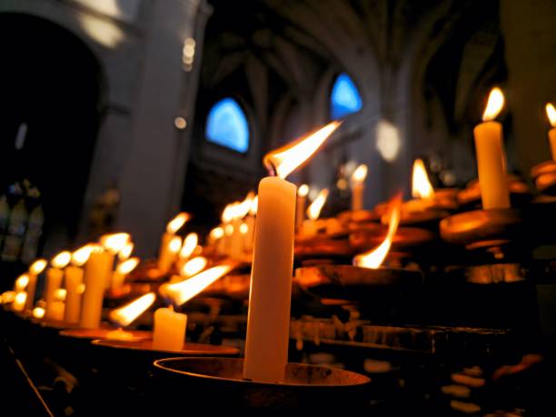 Burning candles in a githic church. Symbol for thinking to the beloves passed away,