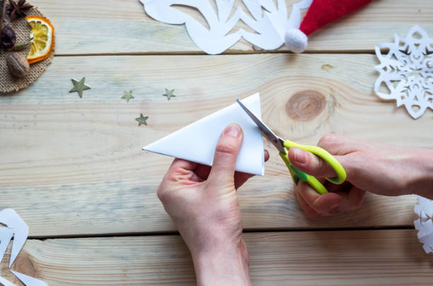 istock A snowflake made from paper with your own hands gracefully decorates a winter interior, adding warmth and a cozy atmosphere 2182334818