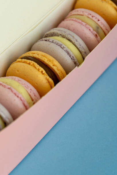 istock delicious almond macaroons in a pink paper gift box on a plain background 2182335327