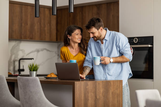 istock Happy Couple Enjoying Morning Coffee in Modern Kitchen 2182335599