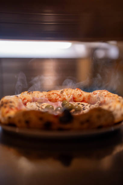 A freshly baked pizza with bubbling cheese and a golden crust. Perfect for social media campaigns, menus, or food ads that highlight the appeal of fresh-out-of-the-oven pizza.
